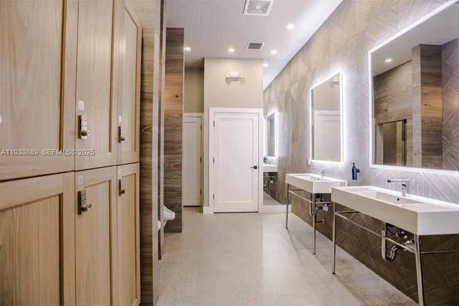 19754 Dinner Key Drive Boca Raton, FL 33498 - Photo 44 of 48 a spacious bathroom with a double vanity sink a mirror and a shower