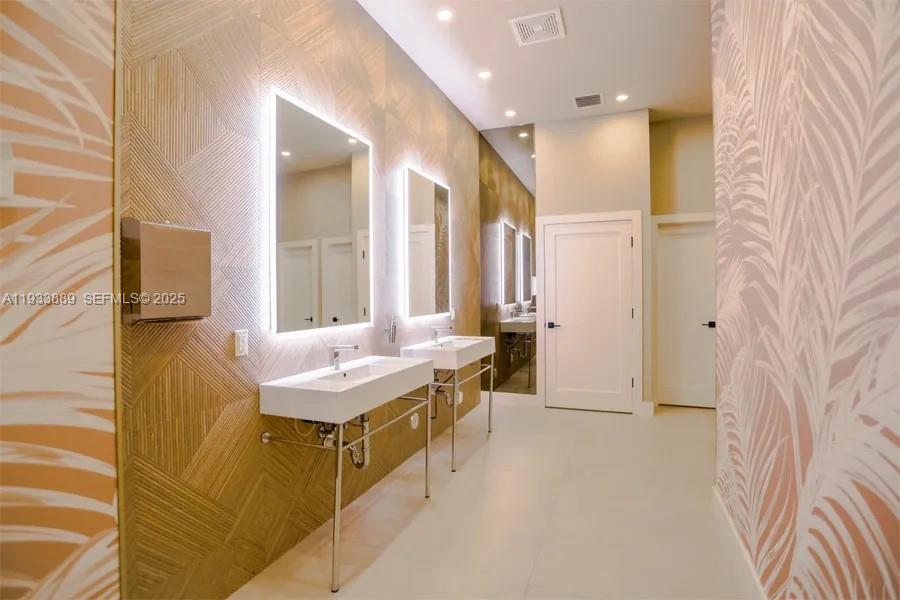 19754 Dinner Key Drive Boca Raton, FL 33498 - Photo 45 of 48 a spacious bathroom with a granite countertop sink and a mirror