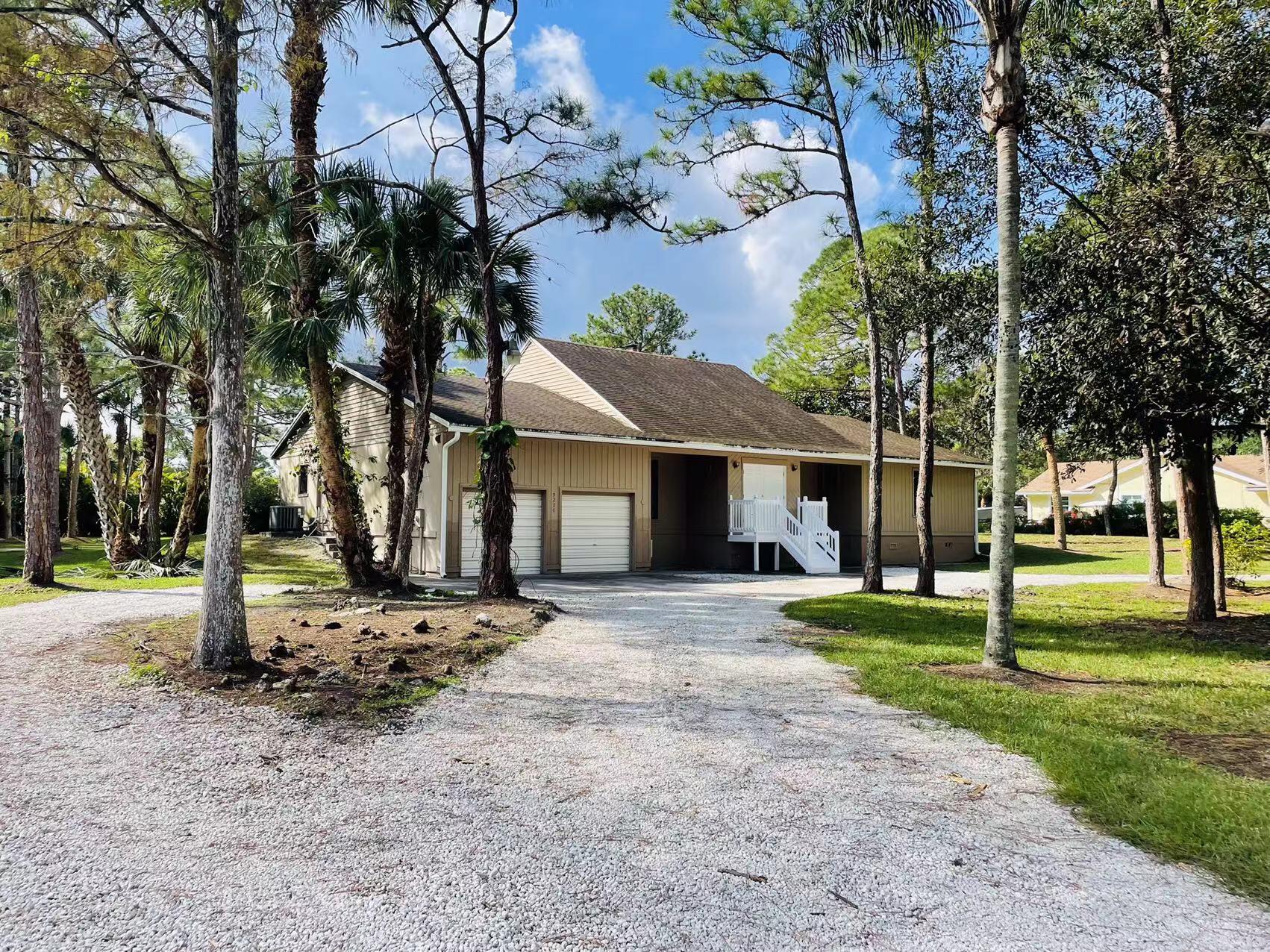 a view of a house with a tree in the background