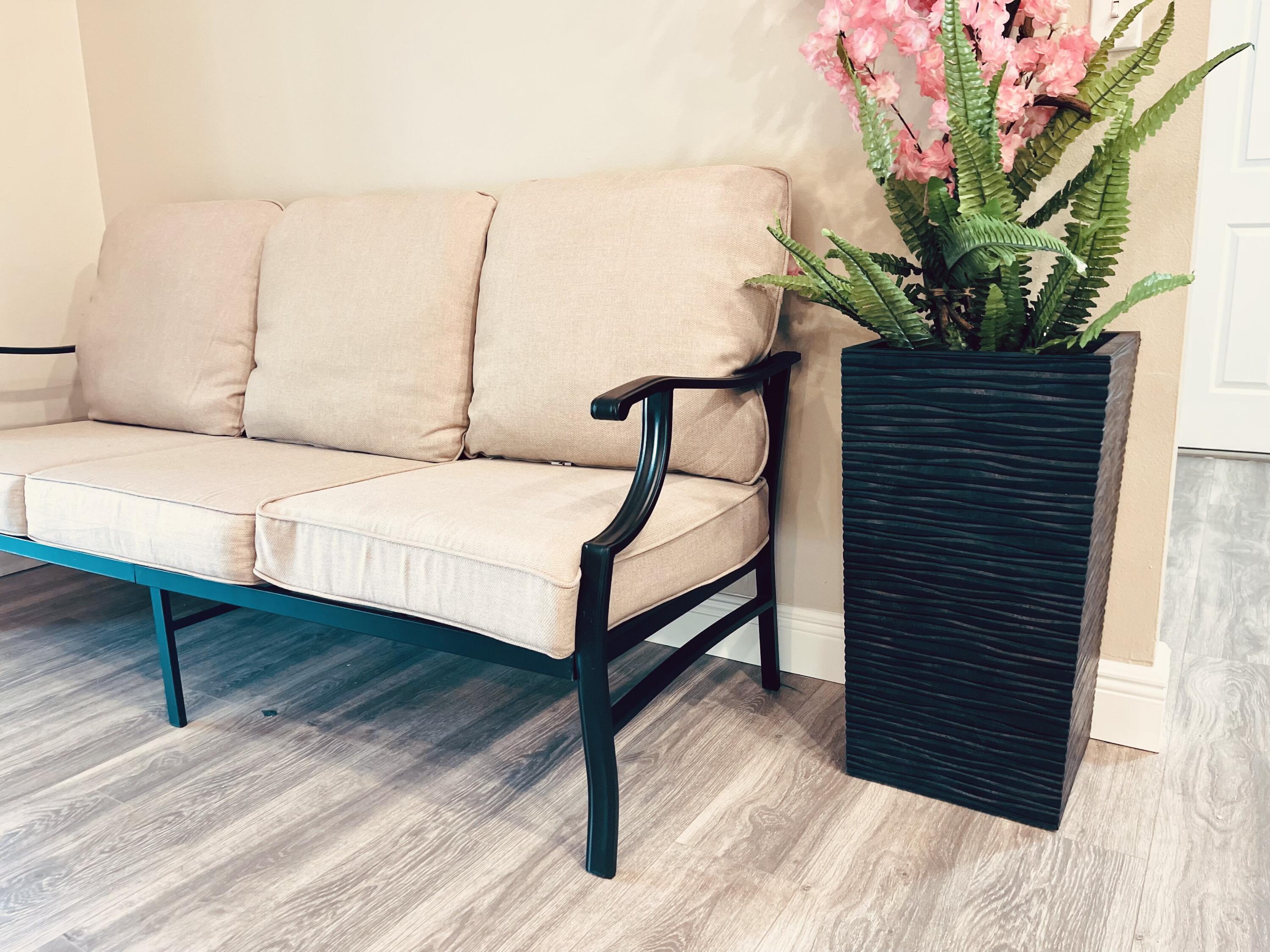 9296 166th Way North Jupiter, FL 33478 - Photo 12 of 31 a bedroom with a bed table chair and a potted plant
