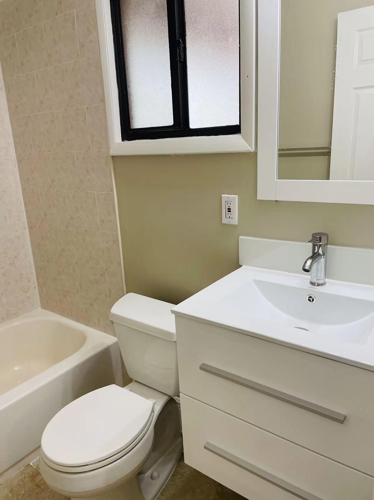 9296 166th Way North Jupiter, FL 33478 - Photo 20 of 31 a bathroom with a sink a mirror and a toilet