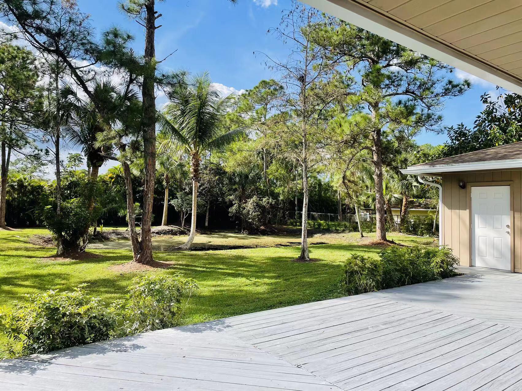 9296 166th Way North Jupiter, FL 33478 - Photo 28 of 31 a view of a swimming pool with a patio