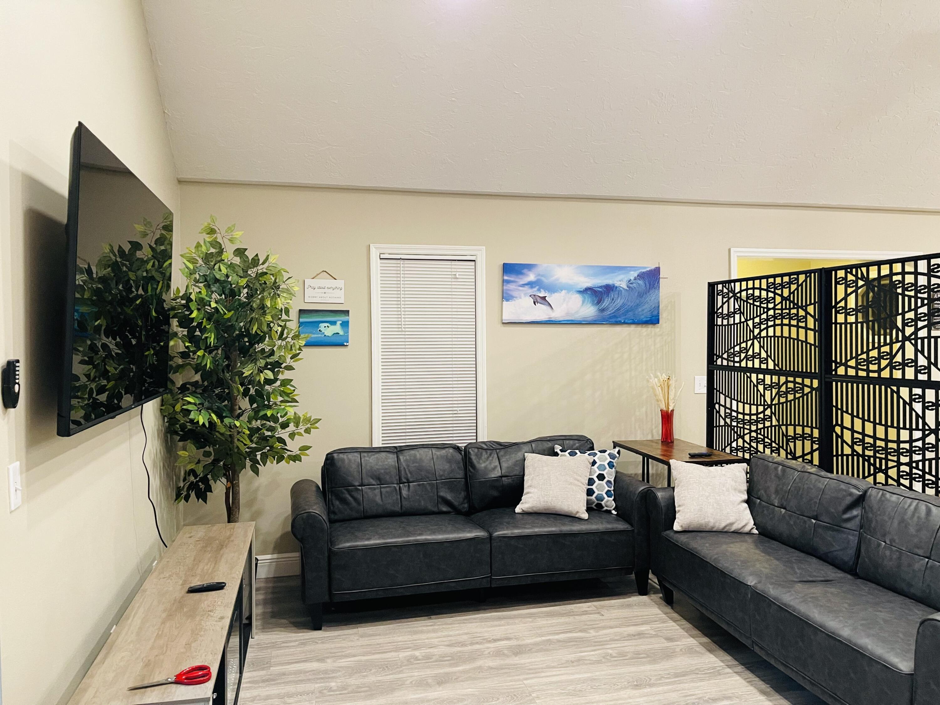 9296 166th Way North Jupiter, FL 33478 - Photo 9 of 31 a living room with furniture and a potted plant