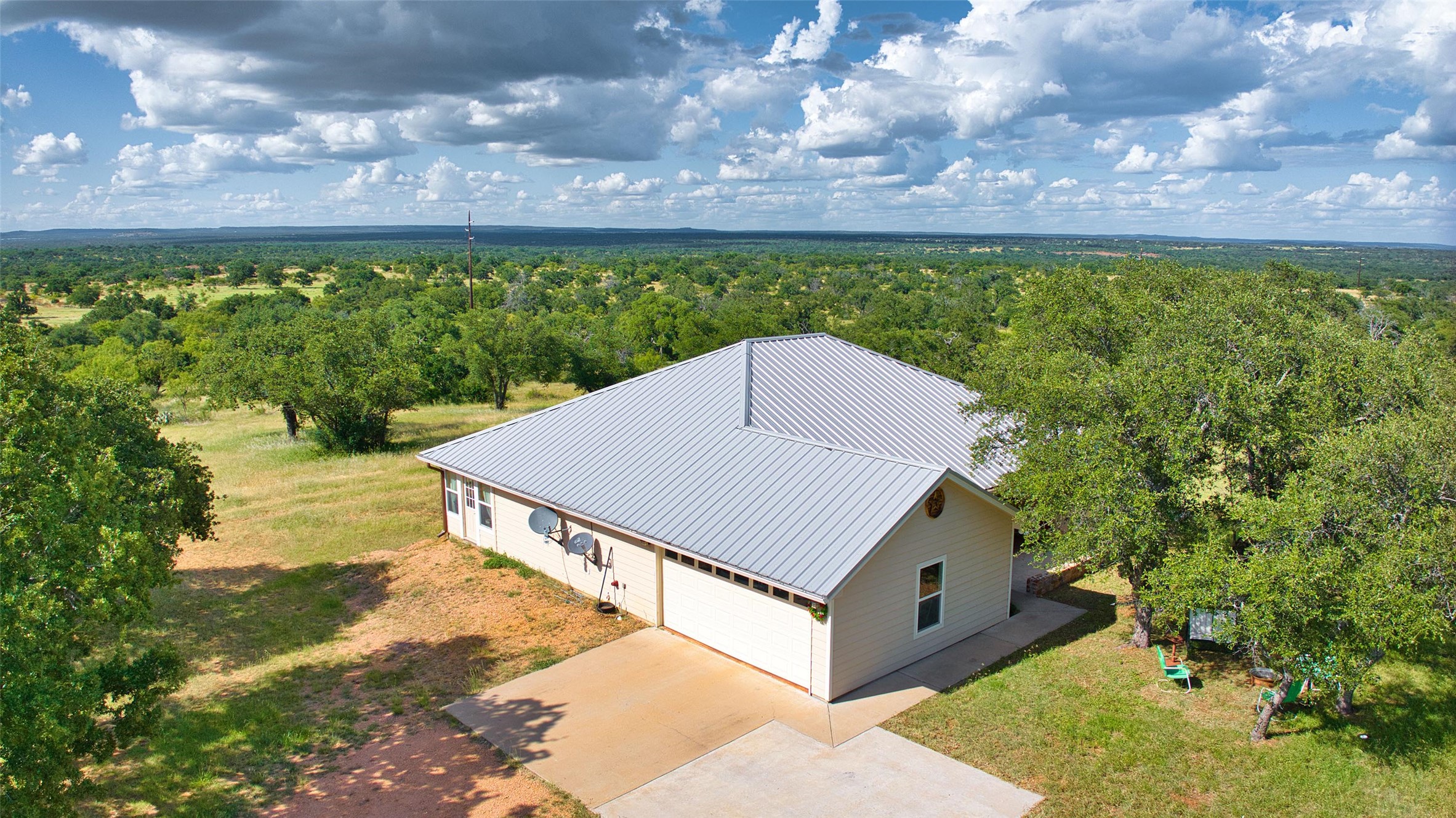 12119 Highway 29 Llano, TX 78643 - Photo 38 of 40 Aerial view of property and surrounding area with a heavily wooded area