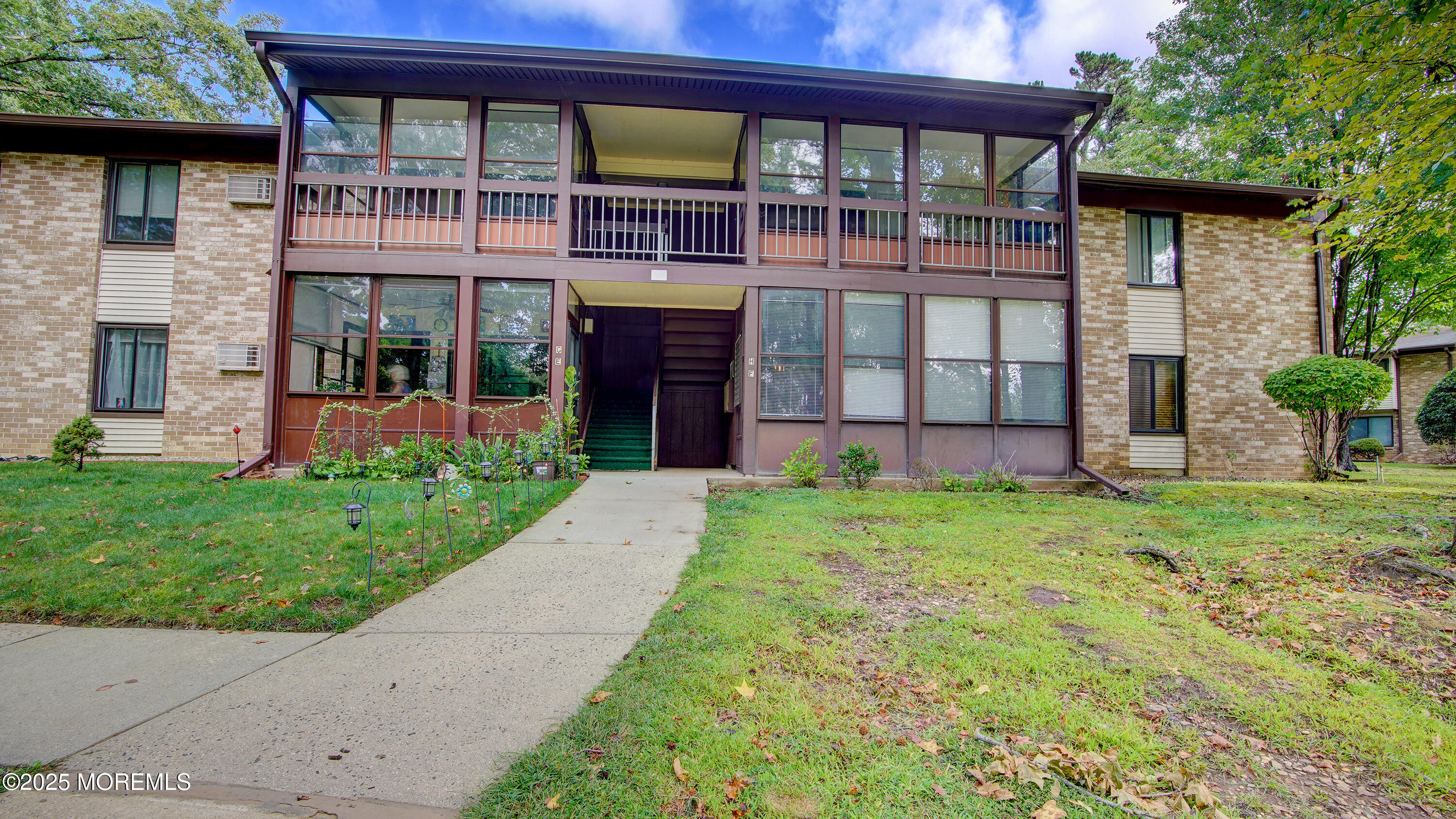 a view of a house with a small yard and a large window