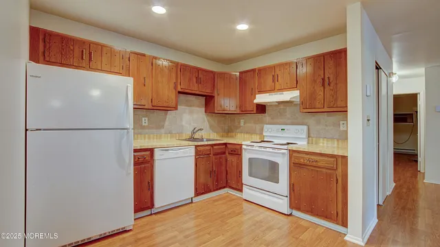 a kitchen with a refrigerator sink and cabinets