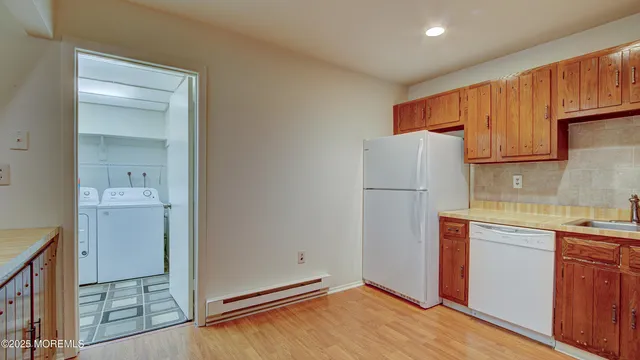 a view of a kitchen with refrigerator and cabinet