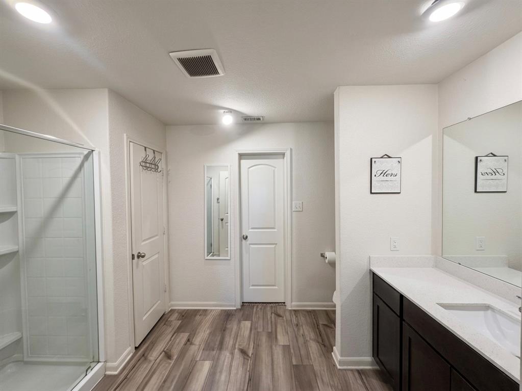 13604 Mineral Road Ponder, TX 76259 - Photo 14 of 20 Bathroom featuring vanity, a shower stall, and light wood-style floors