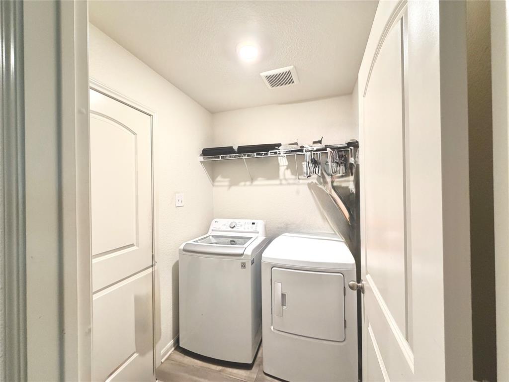13604 Mineral Road Ponder, TX 76259 - Photo 16 of 20 Laundry room featuring washing machine and clothes dryer and light wood-style flooring