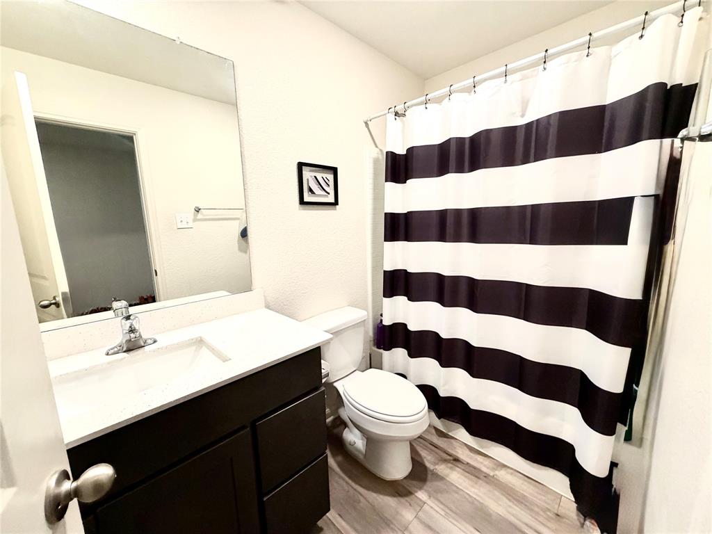 13604 Mineral Road Ponder, TX 76259 - Photo 18 of 20 Full bath with vanity, a shower with shower curtain, and light wood-style floors