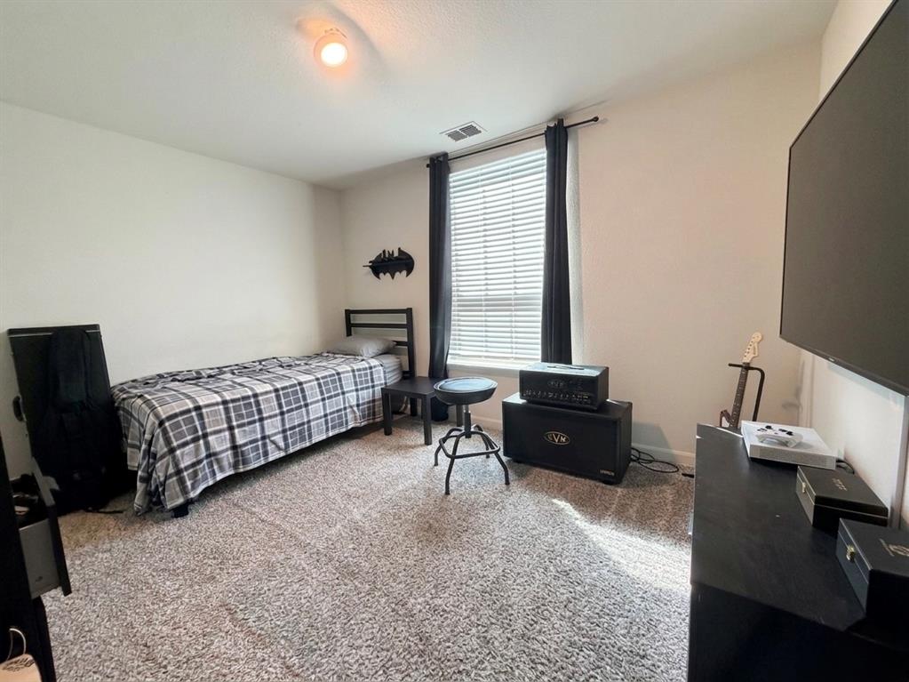13604 Mineral Road Ponder, TX 76259 - Photo 19 of 20 Bedroom featuring light carpet and baseboards