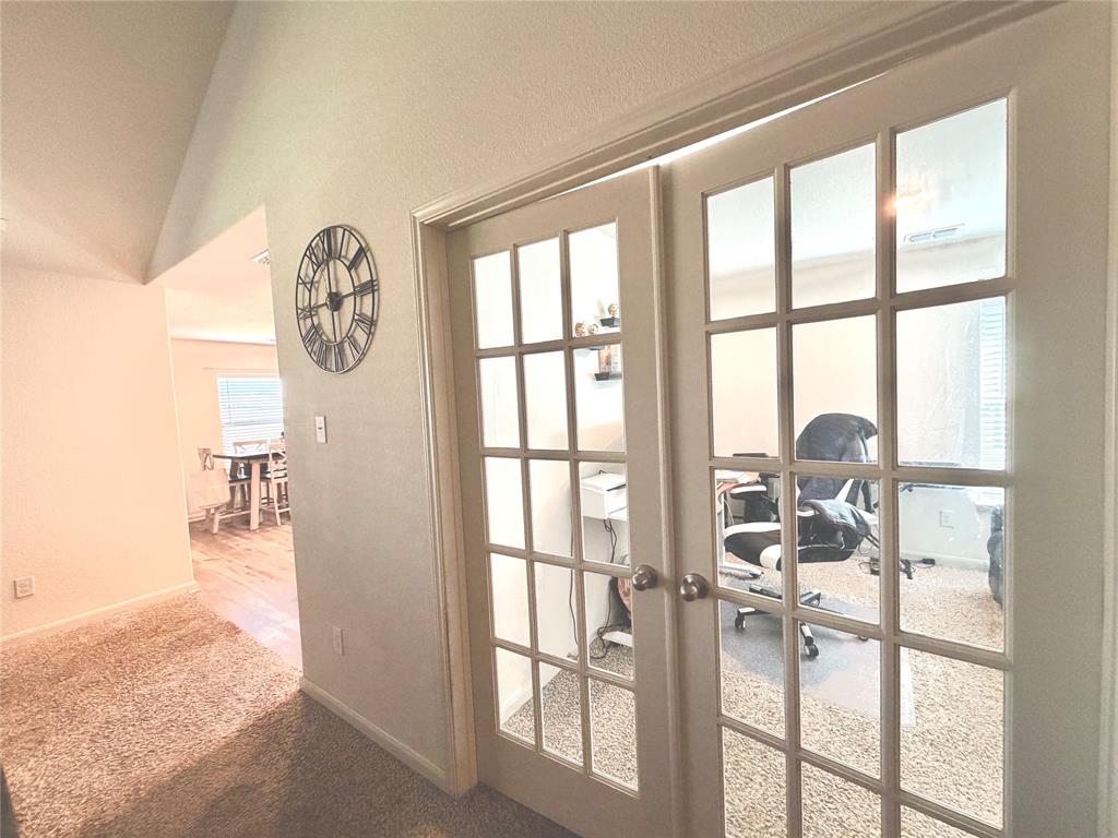 13604 Mineral Road Ponder, TX 76259 - Photo 10 of 20 Doorway with french doors, a desk, a textured wall, carpet flooring, and lofted ceiling