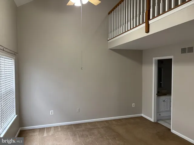 an entryway in a hallway with wooden floor and stairs