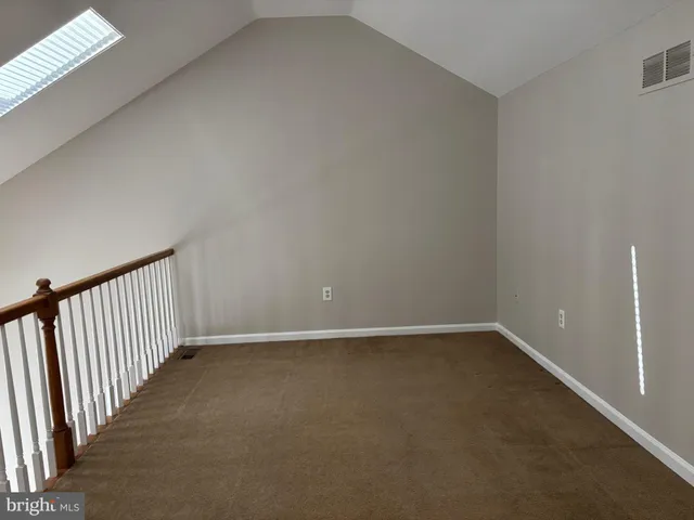 a view of staircase with railing