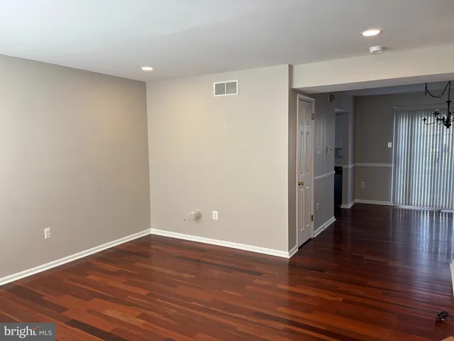 a view of entryway with wooden floor and stairs
