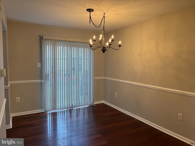 a view of a room with wooden floor and staircase