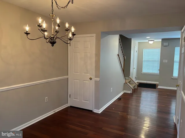 a view of a kitchen with a stove wooden floor and a refrigerator