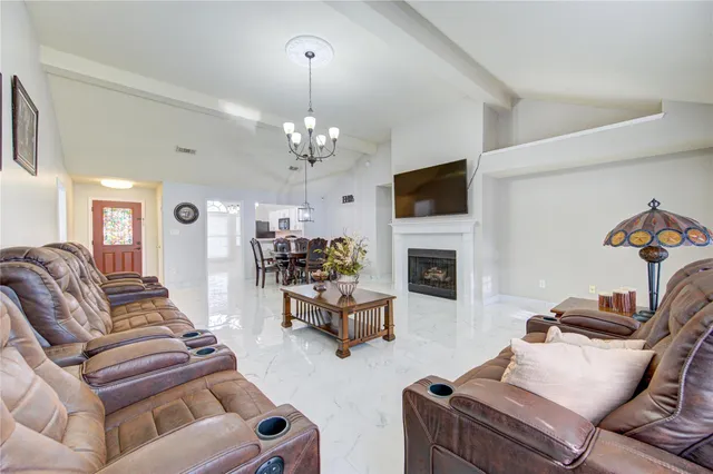 a living room with furniture and a chandelier