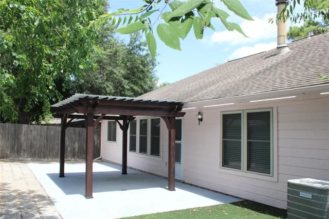 a bathroom with a granite countertop sink a toilet a mirror a vanity and shower