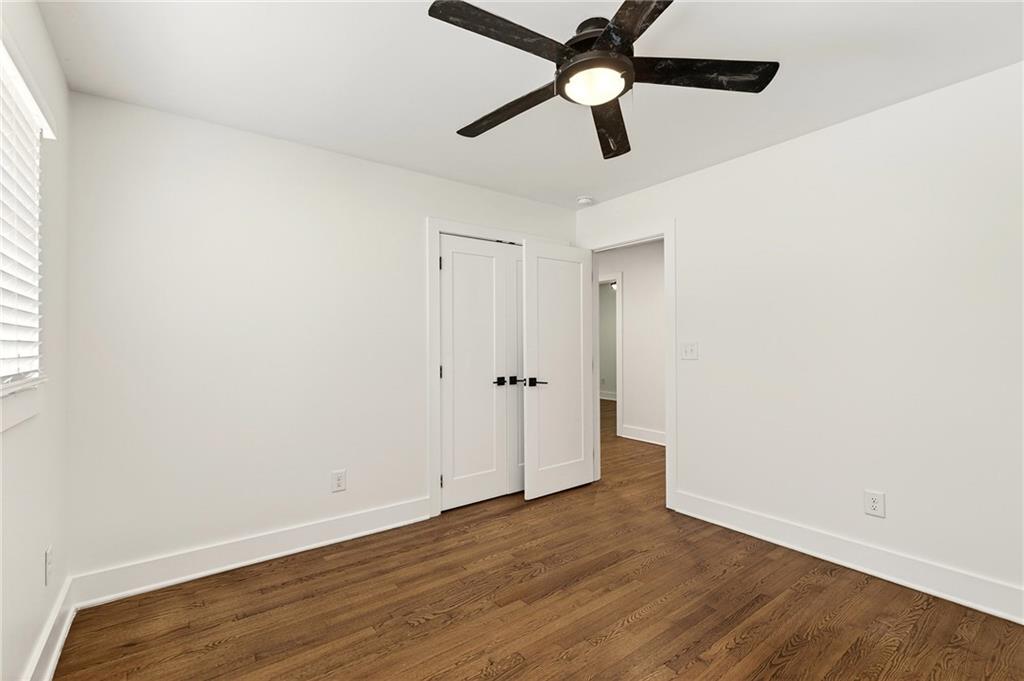 1344 Midlawn Drive Decatur, GA 30032 - Photo 58 of 87 an empty room with wooden floor a ceiling fan and closet