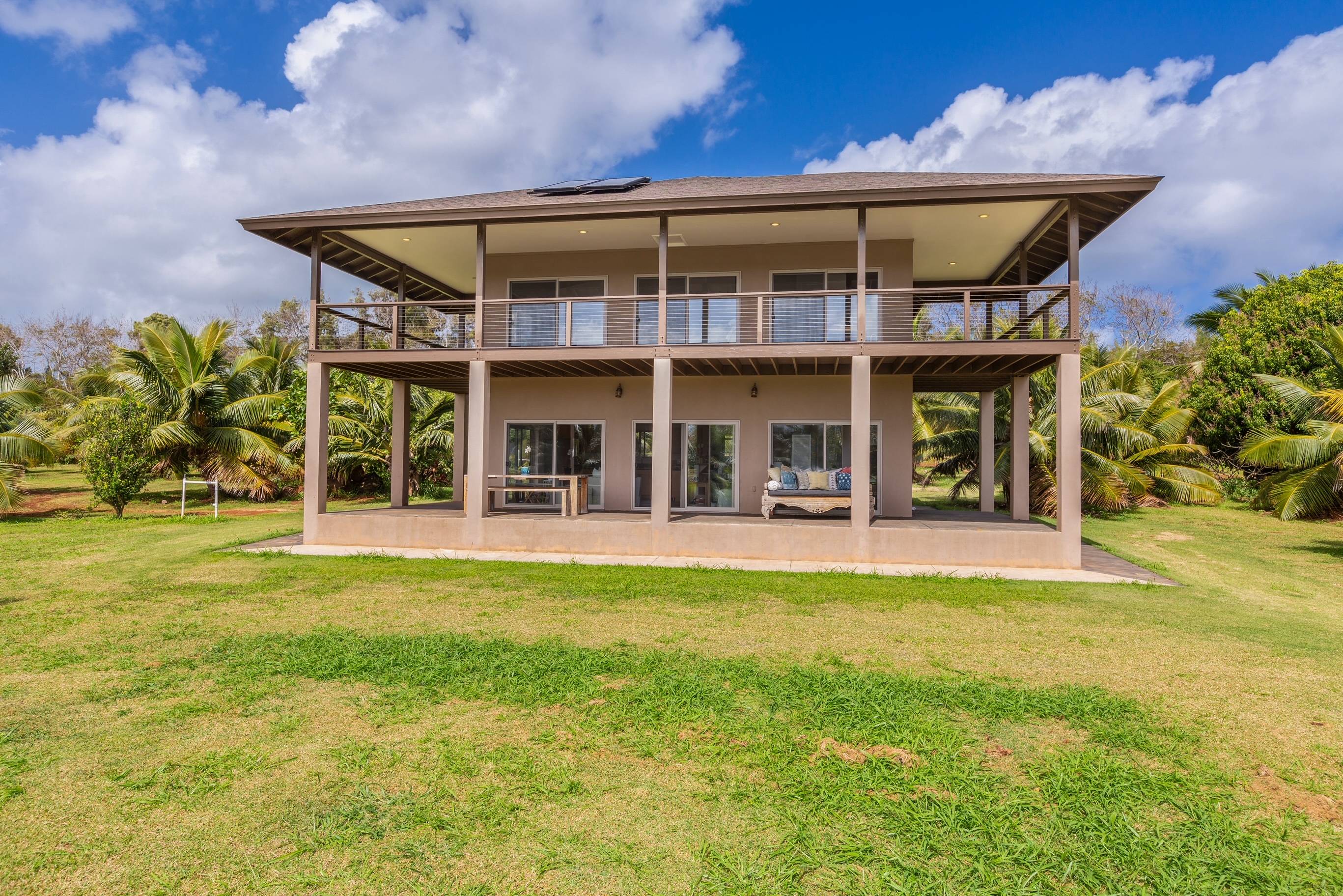 a view of a house with swimming pool and sitting area