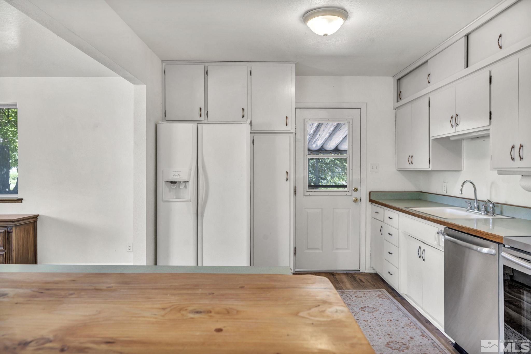 95 East Hwy 95a Yerington, NV 89447 - Photo 23 of 35 a kitchen with white cabinets and window