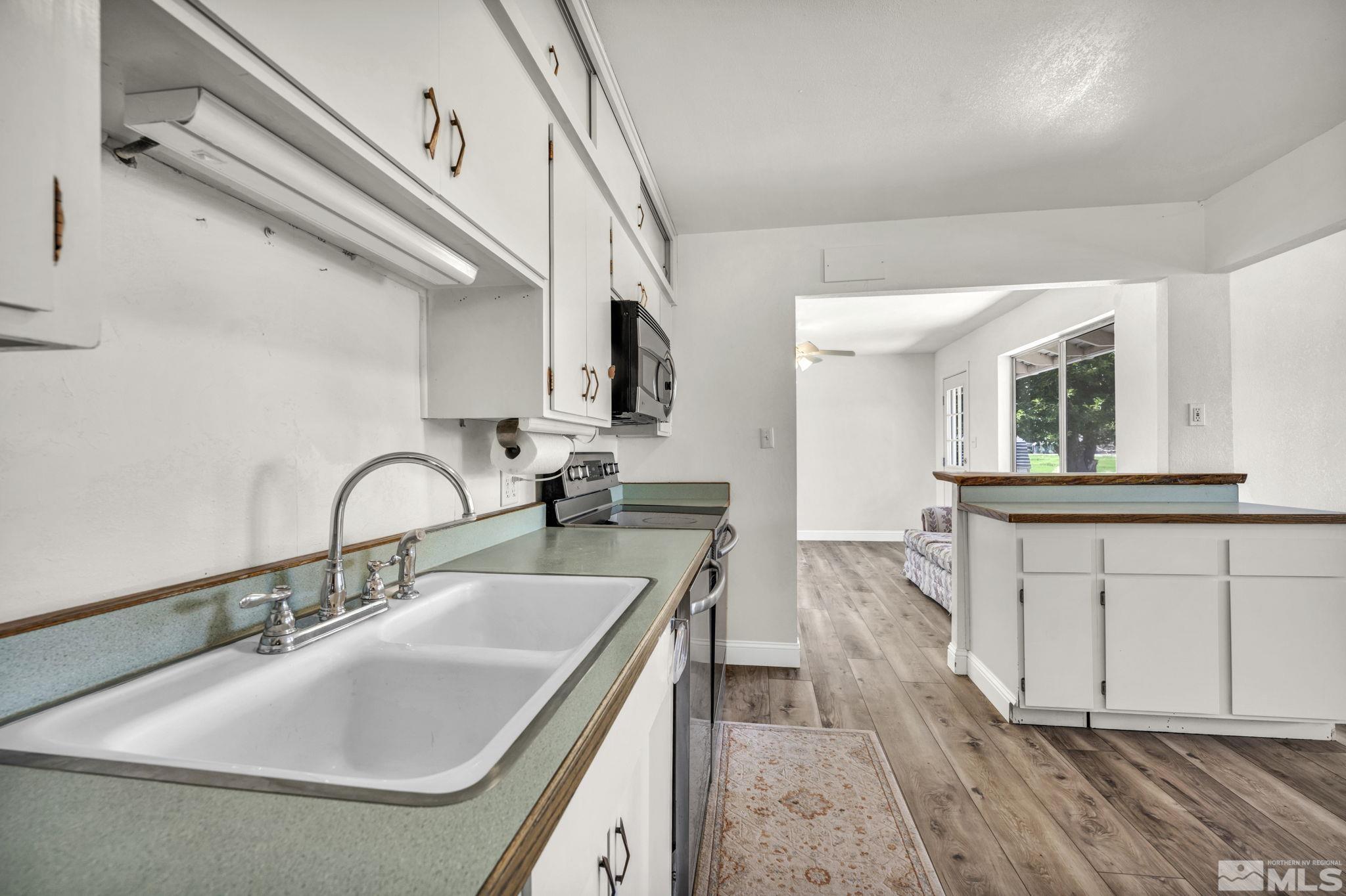 95 East Hwy 95a Yerington, NV 89447 - Photo 24 of 35 a kitchen with sink a faucet and chairs