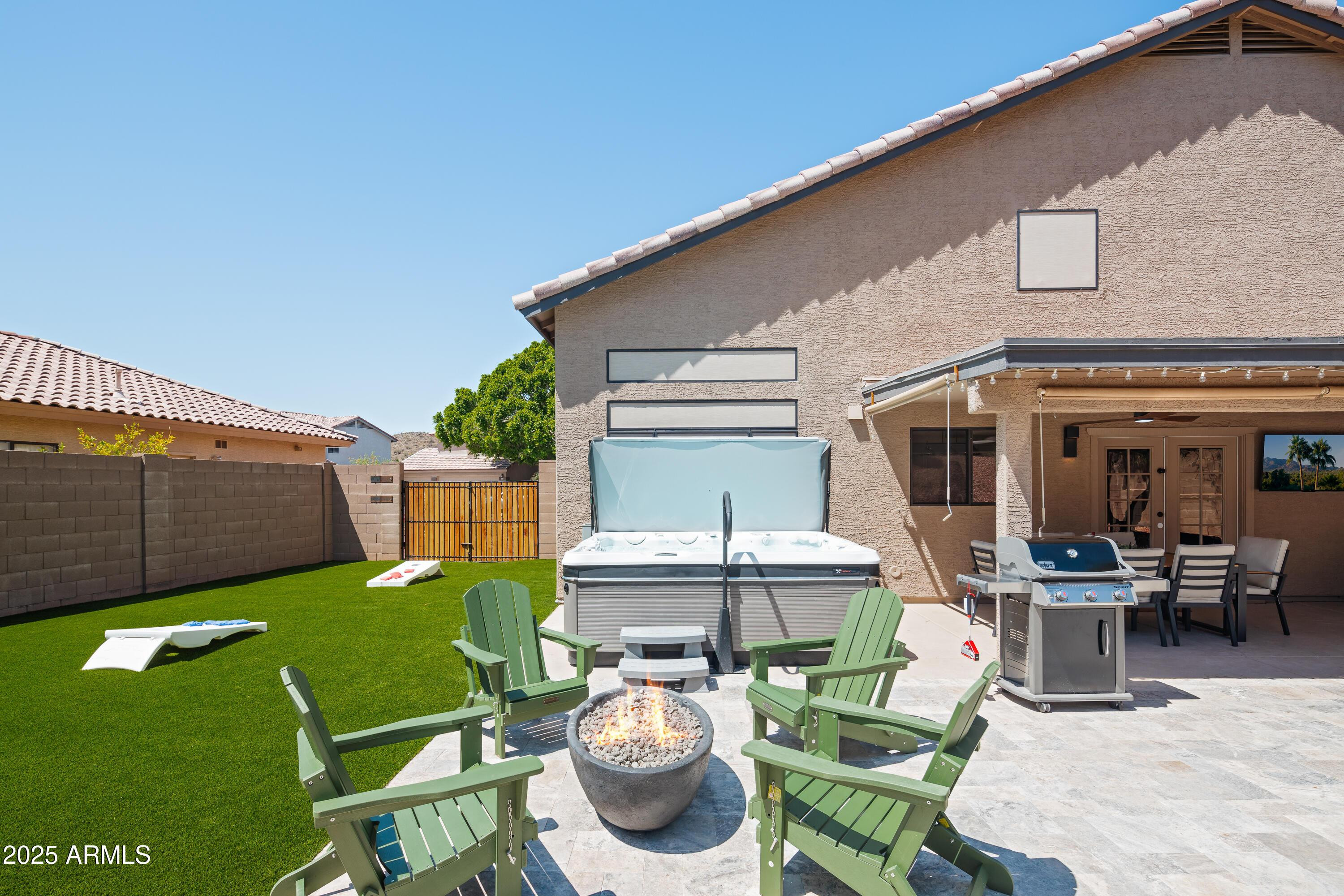 20619 North 16th Way Phoenix, AZ 85024 - Photo 3 of 50 a view of a patio with table and chairs couches fire pit and yard