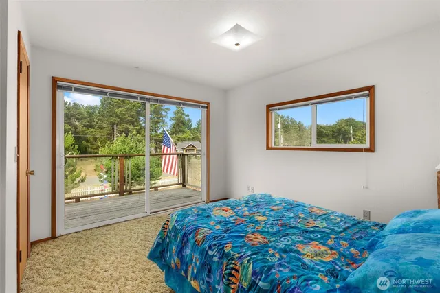 a bedroom with a large bed and a large window