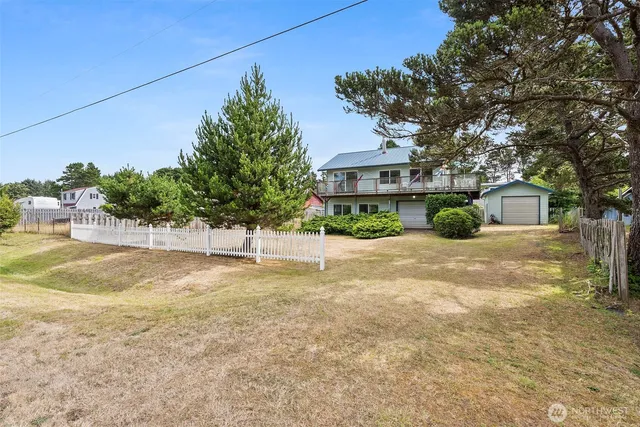 a front view of a house with a yard and a garage