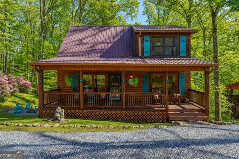 a view of a house with a yard and sitting area