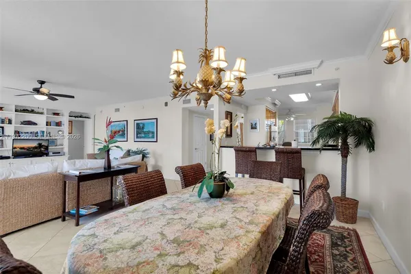 a dining room with furniture and a chandelier