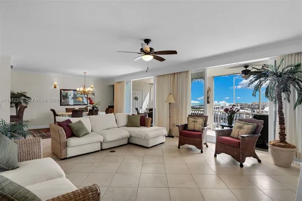 a living room with furniture and a ceiling fan