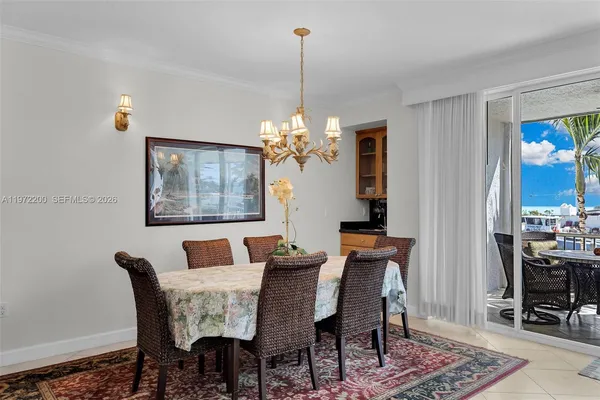 a dining room with furniture a chandelier and wooden floor