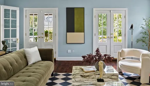 a view of a living room that has a fireplace and a window