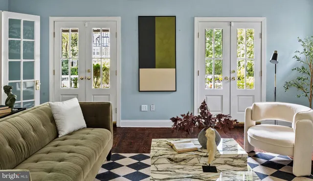 a view of a living room that has a fireplace and a window