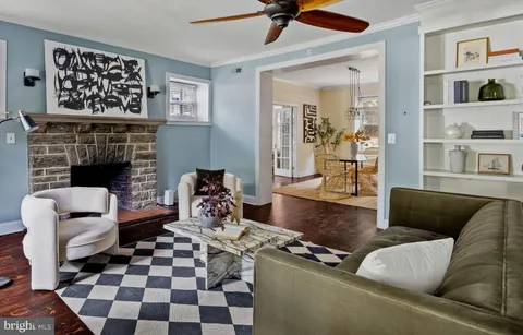 a dining room with furniture wooden floor a chandelier and a rug