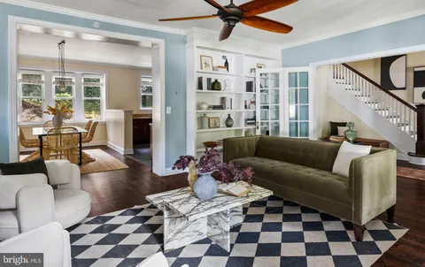 a dining room with furniture a chandelier and wooden floor