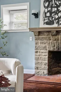 a kitchen with kitchen island granite countertop a table chairs refrigerator and microwave