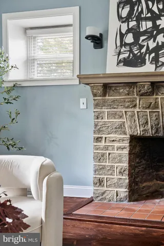 a kitchen with kitchen island granite countertop a table chairs refrigerator and microwave