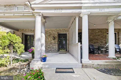 a front view of a house with plants