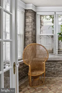 a view of a hallway with wooden floor and a bedroom