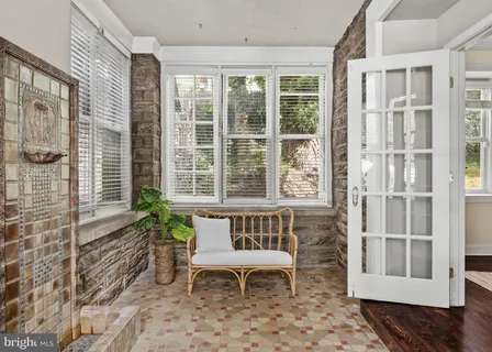 a view of a hallway with wooden floor and entryway