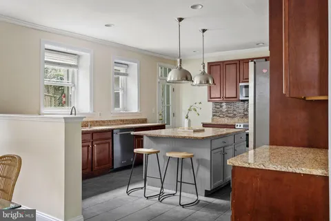 a bedroom with a bed a table and painting on the wall