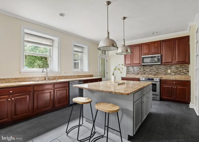 a bedroom with a bed window and walk in closet with window