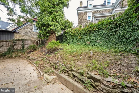 a view of an empty room with wooden floor and closet area