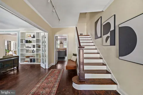 a view of entryway livingroom and hall with wooden floor