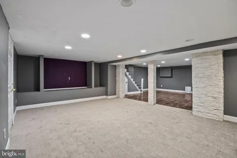 a view of a big room with wooden floor and windows