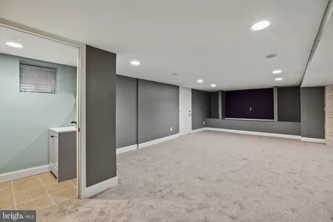 a view of empty room with wooden floor and ceiling fan