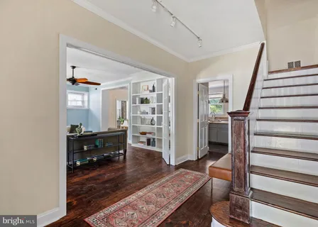 a living room with furniture and a book shelf